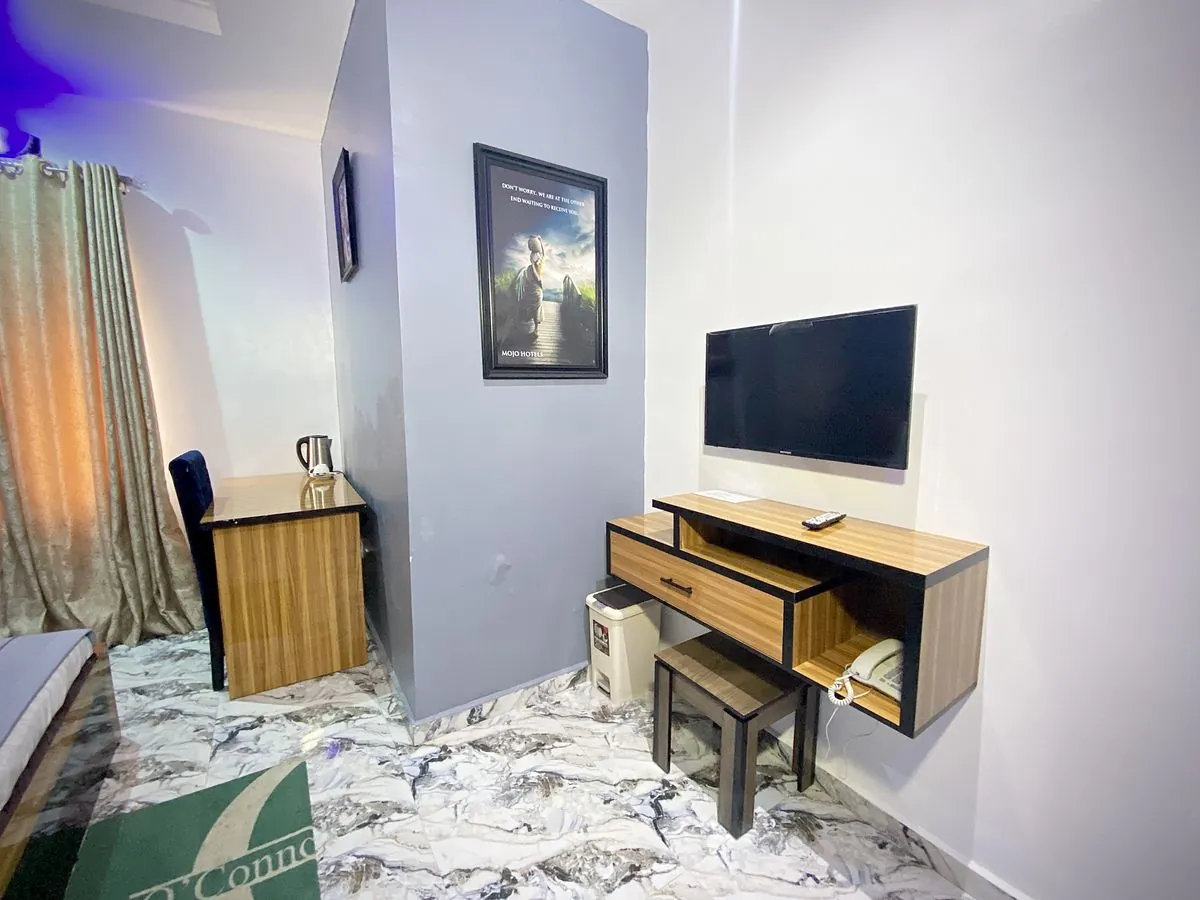 A room's desk, TV and kettle